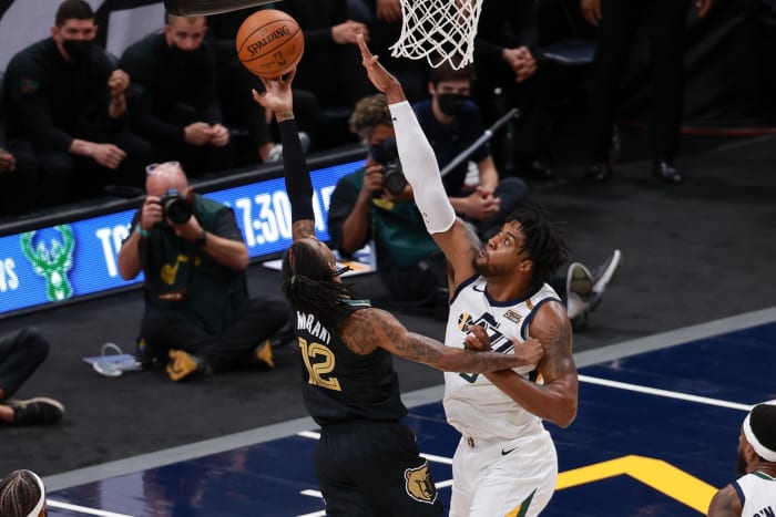 Derrick Favors (15) looks to block Ja Morant (12)